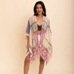 This Bohemian Burnout Velvet Kimono Is A Captivating Blend Of Traditional Charm And Modern Flair. The Garment Showcases A Rich Tapestry Of Colors, Creating A Mesmerizing Visual Effect. Paired With Contemporary Shorts, The Kimono Offers A Striking Contrast That Effortlessly Marries Classic And Modern Styles. Subtle Accessories Like Brown Earrings And A Pink Top Add Layers Of Personality And Style. A Pink And White Shawl Gracefully Draped Around The Shoulders Complements The Vibrant Theme, Adding Bohemian Cream Kimono For Spring, Cream Bohemian Kimono For Spring, Bohemian Beige Kaftan For Spring, Spring Bohemian Beige Kaftan, Beige Bohemian Kaftan For Spring, Feminine Beach Kimono For Summer, Cream Summer Kimono, Summer Cream Kimono, Cream Kimono For Vacation