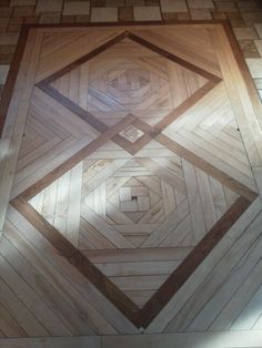 the floor is made out of wood and has an intricate design on it's surface