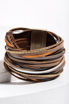 Our On the Line Bracelets are marvelously stackable! This piece features soft flexible leather adorned with a gorgeous sheen that makes it pop. Whether your style is chic, rustic, or in-between, we have a color combination for you. Materials: Leather, Zinc, Alloy Size: 8” x 1.5” Magnetic Clasp Imported Chic Adjustable Double Band Bracelet, Trendy Leather Bracelet As Fashion Accessory, Chic Adjustable Leather Bracelet, Trendy Gold Leather Bracelet, Trendy Brown Bracelet As Fashion Accessory, Trendy Brown Bracelets As Fashion Accessory, Chic Brown Bangle Bracelet, Chic Brown Bracelet Jewelry, Trendy Brown Leather Jewelry