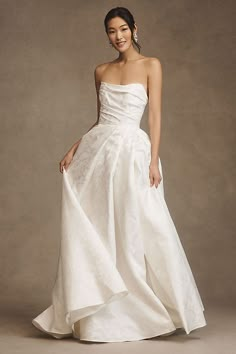 a woman in a white wedding dress posing for the camera