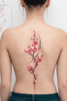 the back of a woman's body with pink flowers on her upper and lower back