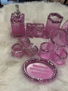 pink bathroom accessories set on white furnishing with sparkles in the middle and bottom