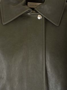 Dark green full-grain lambskin "Aviator" bomber jacket from Alexander McQueen, featuring a wide collar, shoulder pads, two side pockets and a hidden front fastening. Composition: 110 Workwear Leather Jacket With Padded Lapel Collar, Leather Jacket With Padded Lapel Collar For Work, Leather Outerwear With Padded Lapel Collar, Green Leather Jacket With Pockets For Work, Leather Collared Jacket With Concealed Placket, Collared Leather Jacket With Concealed Placket, Classic Green Leather Outerwear, Modern Collared Leather Jacket, Chic Green Leather Jacket For Work