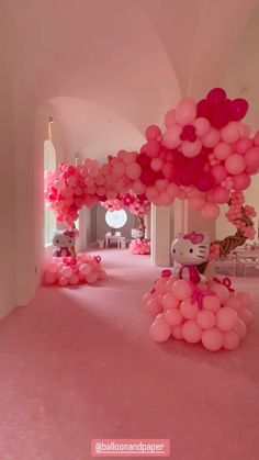 hello kitty balloon arch with pink and white balloons on the floor in front of it