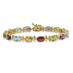 14k yellow gold 13.45 cttw rainbow gemstone bracelet. Measures approximately 3/16 of an inch in width and has a box catch closure. Rainbow Gemstones, Yellow Gemstones, Red Gemstones, Peridot Gemstone, Citrine Gemstone, Green Gemstones, Garnet Gemstone, Blue Gemstones, Topaz Gemstone