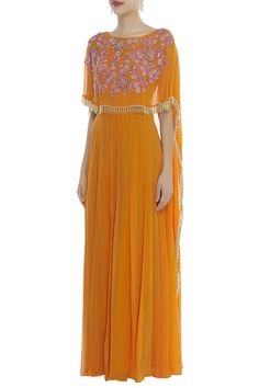 Orange georgette jumpsuit with floral embroidery on the attached cape and flared drape at the back.
Components: 1
Neckline: Round
Sleeve length: Half
Beaded tassel hem
Keyhole back
Closure: Back zip - Aza Fashions Anarkali Palazzo Set With Cape Sleeves In Georgette, Anarkali Party Dress With Cape, Party Anarkali Dress With Cape Shape, Evening Palazzo Set With Cape Sleeves, Party Anarkali Dress With Cape, Designer Georgette Palazzo Set With Cape Sleeves, Festive Georgette Dresses With Cape Sleeves, Traditional Georgette Cape Dress, Cape Sleeves Anarkali Set For Party