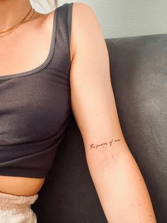 a woman with a small tattoo on her arm