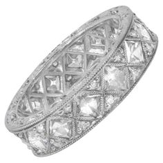 A breathtaking platinum band adorned with fourteen stunning French-cut diamonds. Each diamond is meticulously set in fine milgrain bezels, complemented by pave set diamonds on both sides. The band features an additional row of milgrain on each side, enhancing its elegance, and boasts beautiful hand engraving. With a width of approximately 5mm, this captivating band holds a total diamond weight of approximately 1.79 carats, making it a timeless and luxurious piece. Ring Size: 6.5 US, Resizable Me French Cut, Stone Cuts, Hand Engraving, Diamond Stone, Diamond Wedding Bands, Beautiful Hand, Diamond Wedding, Cut And Style, Band Rings