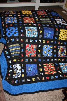 a blue and black quilt on the floor