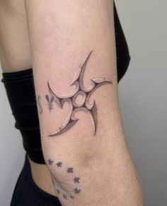 a woman's arm with a tattoo on it and stars around the arm area