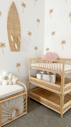 two baby cribs in a room with palm trees on the wall