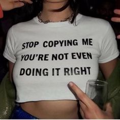 a woman wearing a t - shirt that says stop copying me you're not even doing it right