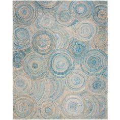 an abstract rug with blue and beige circles on the bottom, in front of a white background