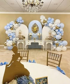 a table topped with blue and white balloons