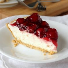 a piece of cheesecake with cherries on top