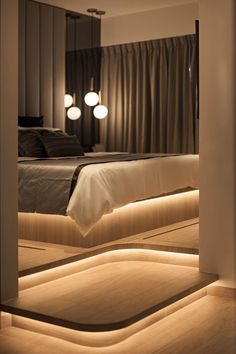 a large bed sitting under two lamps in a bedroom