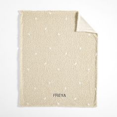 a blanket with white dots on it and the word freya written in black