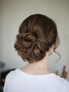 a woman with her hair in a low bun