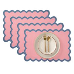 three placemats with forks and spoons on top of each other in front of a white plate