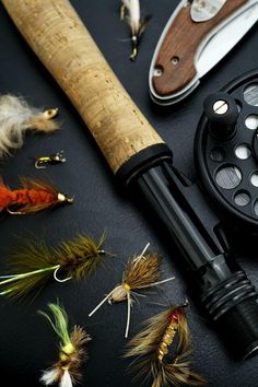 various types of fly fishing equipment on a table