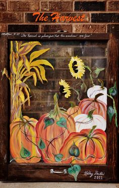 a painting of pumpkins and sunflowers on a brick wall with the words, the harvest