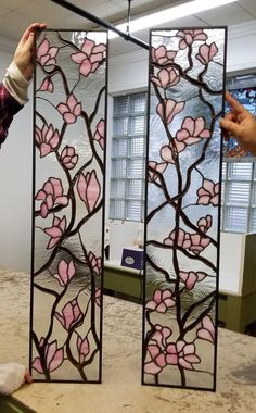 two stained glass panels with pink flowers on them