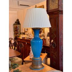 a blue lamp sitting on top of a wooden table