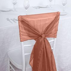 an orange chair sash on top of a white table