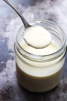 a spoon full of yogurt sitting on top of a table