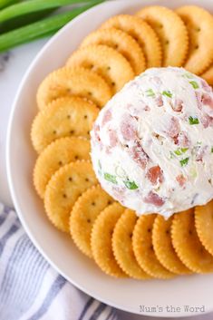 a white plate topped with crackers and a cheese ball