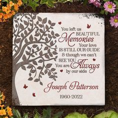 a memorial plaque is surrounded by flowers and leaves