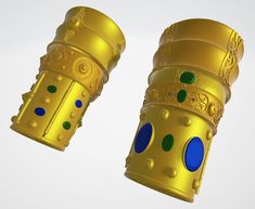 two golden objects with blue and green dots on them