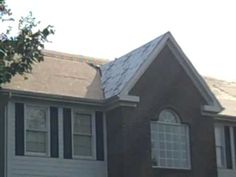 a house with two windows and a white roof