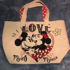 Used Once ! Super Cute And Wide ! Absolutely Love This One. Note: There Is A Little Black Stuff In A Small Area At The Bottom Of The Purse But It Is Unnoticeable Casual White Minnie Mouse Bag, Cheap Mickey Mouse Rectangular Bag, Shirts With Holes, Minnie Mouse Bag, Cute Mickey Mouse Bags For Travel, Black Minnie Mouse Travel Bag, Disney Tote Bags, Disney Tote, Playful Minnie Mouse Travel Bag