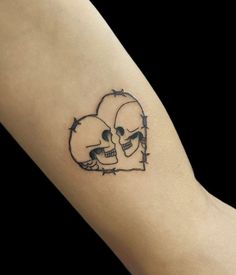 a couple of skulls with barbed wire on their arm