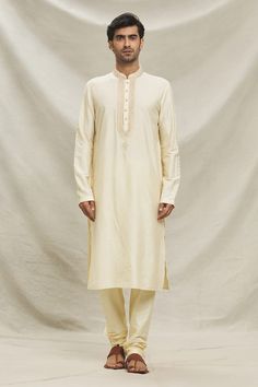 Beige straight kurta with pintuck pattern and embroidered collar, placket. Paired with a pyjama. - Aza Fashions Festive Traditional Kurta With Relaxed Fit, Traditional Relaxed Fit Kurta For Festive Occasions, Festive Cotton Kurta With Pintucks, Cotton Straight Kurta With Pintucks, Traditional Straight Kurta With Pintucks, Traditional Long Sleeve Kurta With Pintucks, Classic Long Sleeve Cotton Traditional Wear, Traditional Kurta With Pintucks For Eid, Traditional Festive Kurta With Pintucks