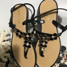 Elegant Comfortable Black Sandals Brand New. Price Is Firm Black T-strap Sandals For Summer, Black Round Toe T-strap Sandals For Summer, Black Toe Post Sandals For Beach, Black T-strap Sandals For Summer Vacation, Black Flat T-strap Sandals For Spring, Black Adjustable Summer Sandals, Black T-strap Sandals For Spring Vacation, Black Summer T-strap Sandals For Beach, Black Flat T-strap Sandals In Synthetic Material