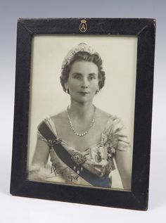 an old black and white photo of a woman wearing a tiara