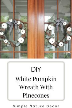 a white pumpkin wreath with pinecones is hanging on the front door, next to a