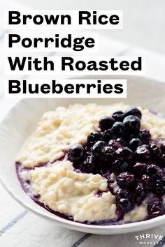 brown rice porridge with roasted blueberries in a white bowl on a striped cloth