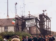 a group of people standing in front of a building with a sign that says ireland