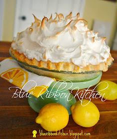 a lemon meringue pie sitting on top of a wooden table