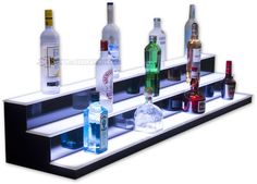 an assortment of liquor bottles are lined up on a shelf