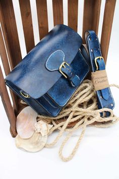 Real leather satchel style bag in rich blue distressed effect finish, Gold buckle with magnetic catch, front pocket and signature adjustable strap with shoulder protector. Dimensions Width 24cm Height 19cm Depth 7cm Front pocket measures 18cm by 14cm by 3cm depth Vintage Blue Satchel For Daily Use, Blue Rectangular Saddle Bag With Detachable Strap, Blue Saddle Shoulder Bag, Blue Leather Satchel Flap Bag, Blue Vintage Satchel With Detachable Strap, Blue Saddle Bag With Adjustable Strap For Daily Use, Blue Satchel Shoulder Bag With Hasp Closure, Blue Satchel Saddle Bag For Travel, Blue Leather Saddle Bag With Adjustable Strap