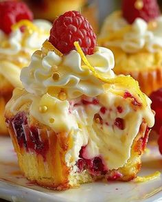 raspberry and lemon cupcakes with whipped cream on top