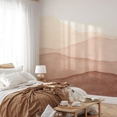 a bed room with a neatly made bed and a wall mural