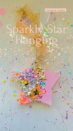 sparkly star hanging with confetti and streamers in the foreground, against a white background