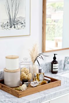 a bathroom counter with soaps and lotions on it