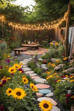 a garden with lots of flowers and lights strung over the back yard, including sunflowers