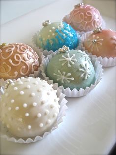 there are many different types of chocolates on the white plate with snowflakes